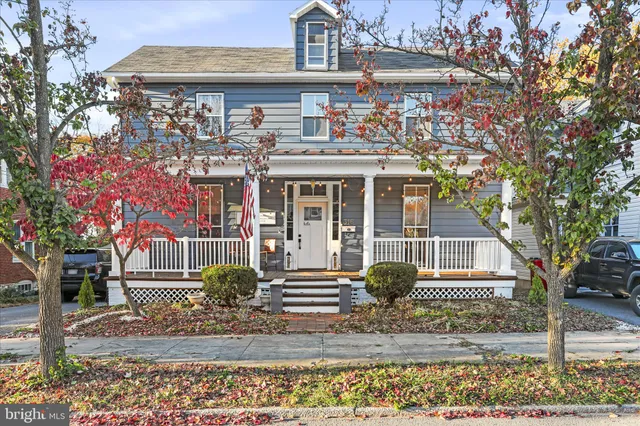 a front view of a house with a garden and plants