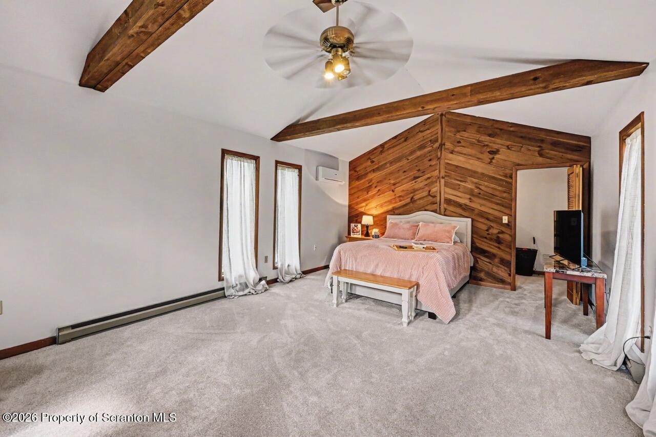 719 Scott Road Clarks Summit, PA 18411 - Photo 21 of 51 a bedroom with a bed and a chandelier