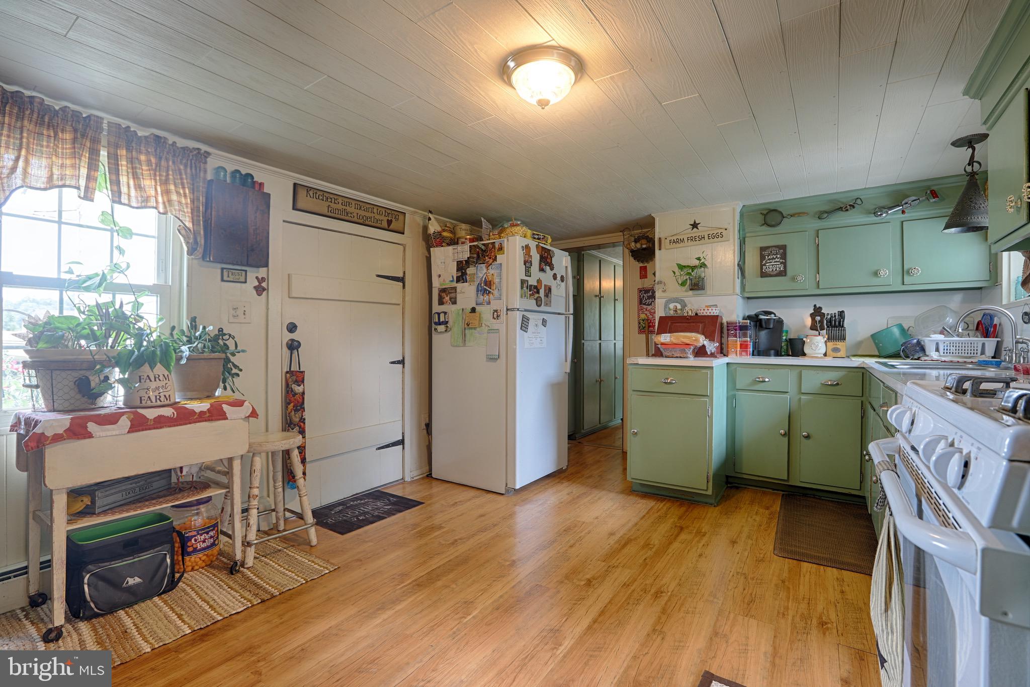 25439 Towers Road Denton, MD 21629 - Photo 22 of 40 a room with a refrigerator and a wooden floor