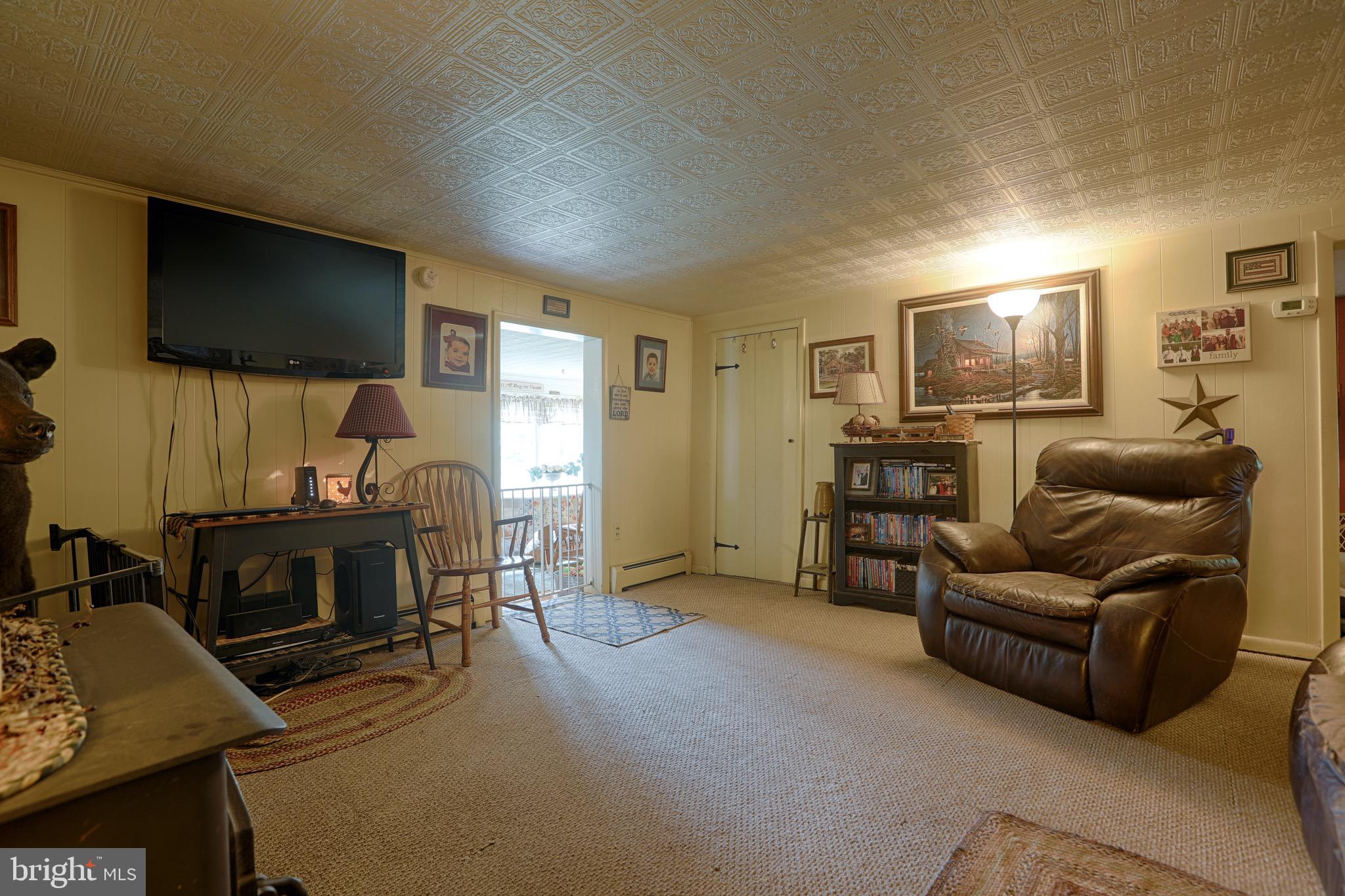 25439 Towers Road Denton, MD 21629 - Photo 28 of 40 a living room with furniture and a flat screen tv