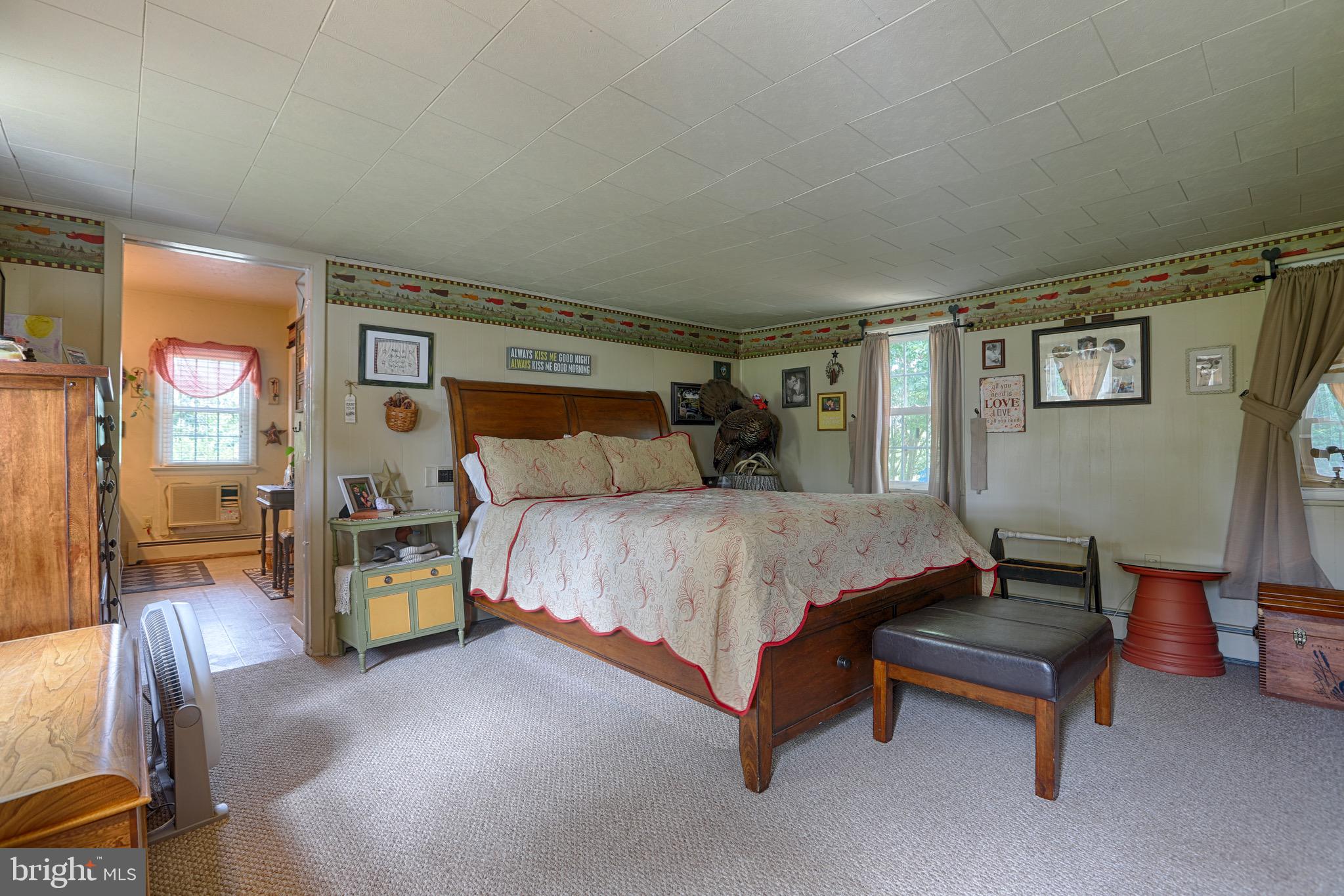 25439 Towers Road Denton, MD 21629 - Photo 35 of 40 a bedroom with a bed and wooden floor