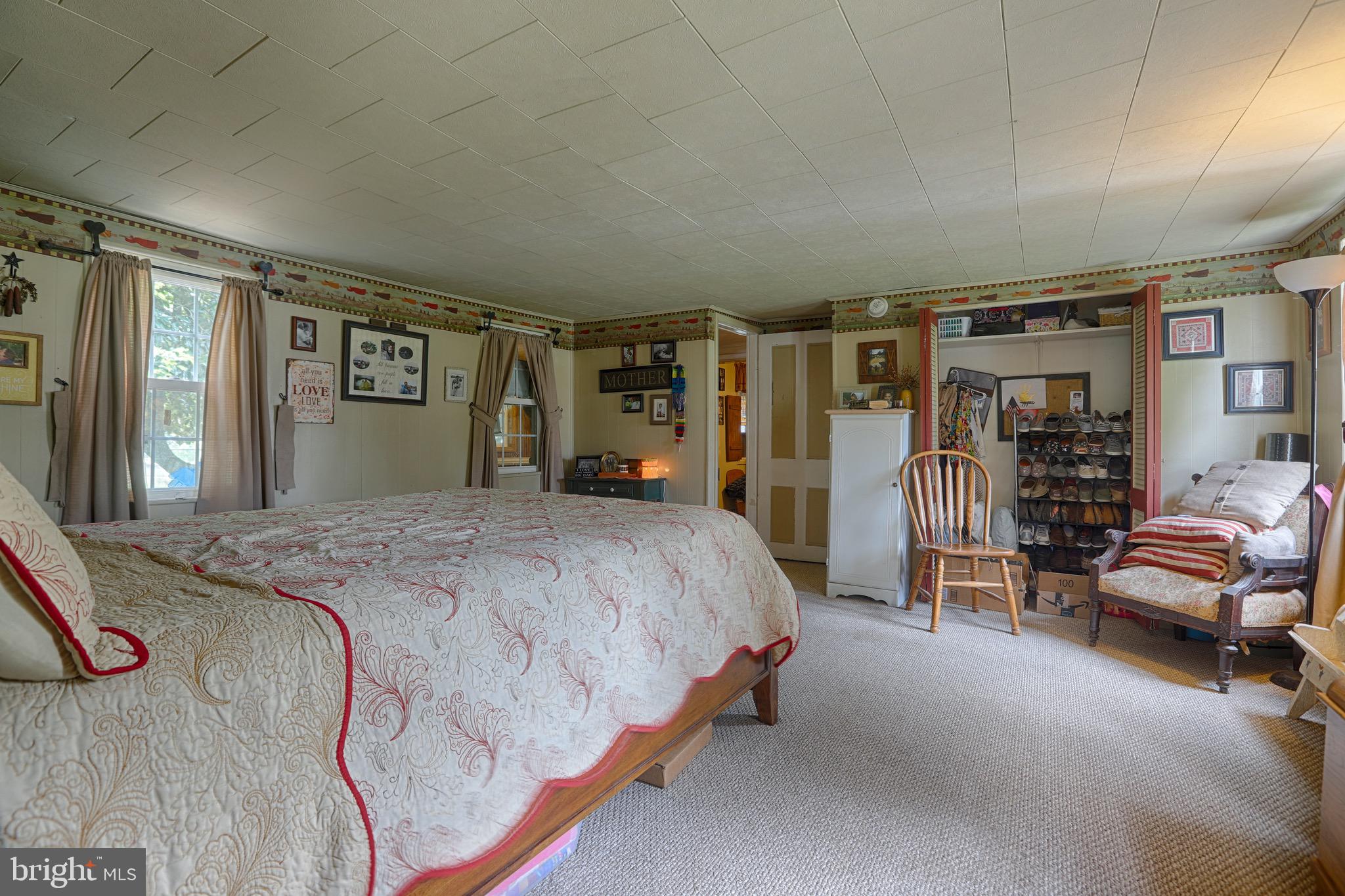 25439 Towers Road Denton, MD 21629 - Photo 36 of 40 a spacious bedroom with a bed and gym equipment
