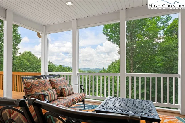 a view of a chair and tables in the patio