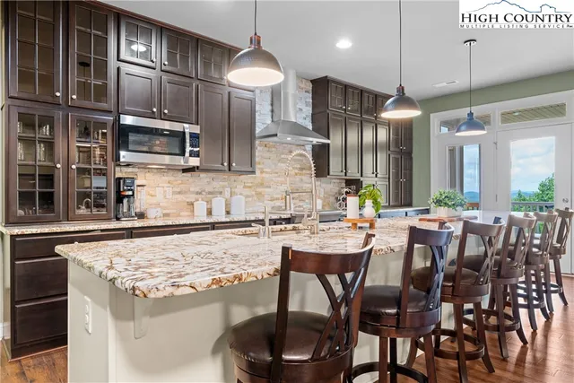 a kitchen with a table chairs stove and cabinets