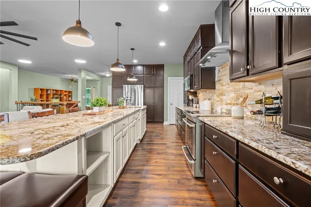 a large kitchen with stainless steel appliances kitchen island granite countertop a large counter top