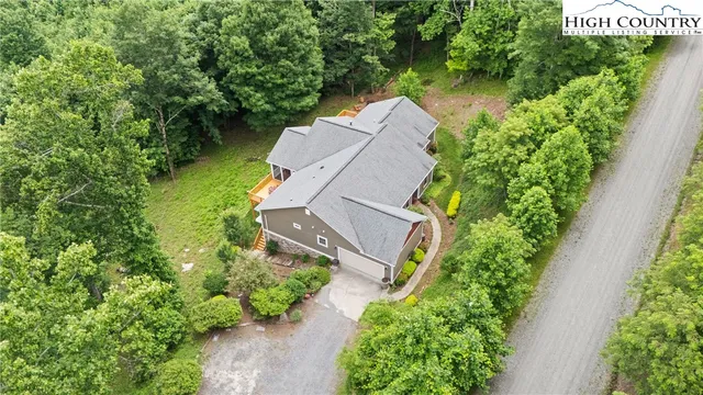 an aerial view of a house with garden space and street view