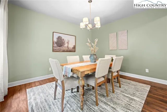 a view of a dining room with furniture wooden floor and a chandelier
