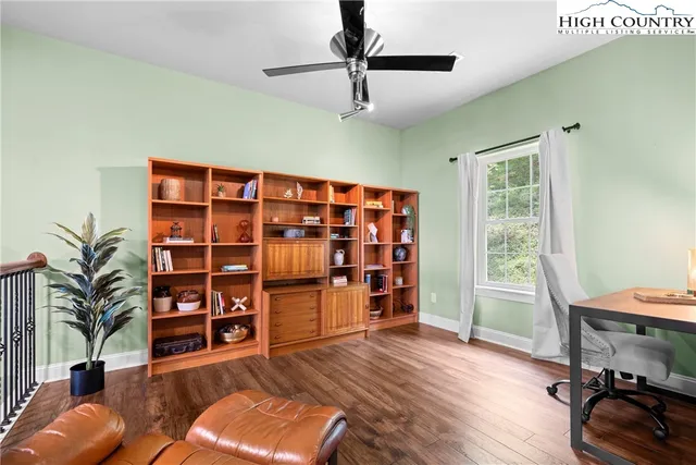 a living room with furniture and a book shelf