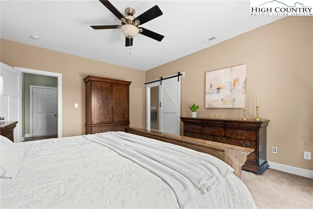 a bedroom with a bed and a large mirror