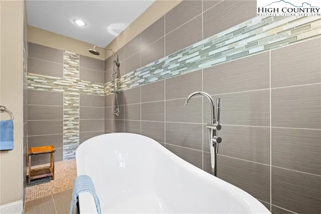 a bathroom with a bathtub and shower