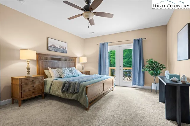 a spacious bedroom with a bed a window and potted plant