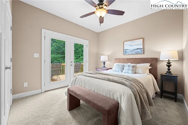 a spacious bedroom with a bed and a chandelier