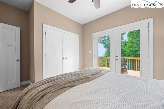 a bedroom with a large bed and a large window