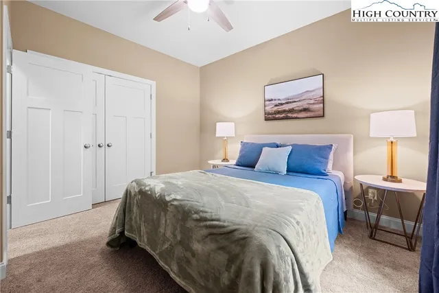 a bedroom with a bed and a lamp