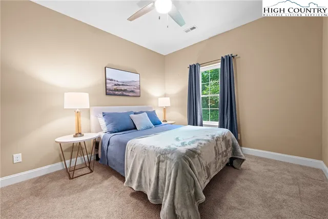 a spacious bedroom with a bed and a window