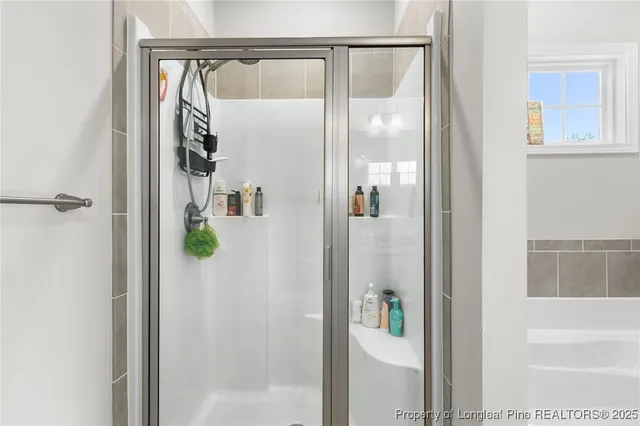a bathroom with a shower and mirror