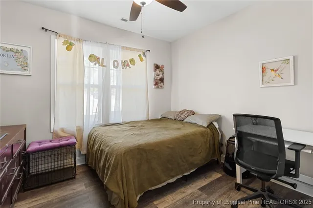 a bedroom with a bed chair and window