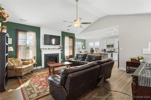 a living room with furniture fireplace and a flat screen tv