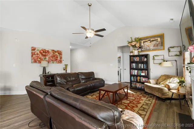 a living room with furniture a couch and a bookshelf
