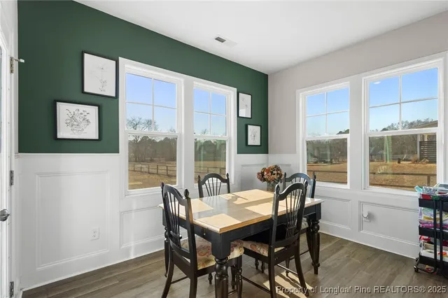 a view of a dining room with furniture window and wooden floor