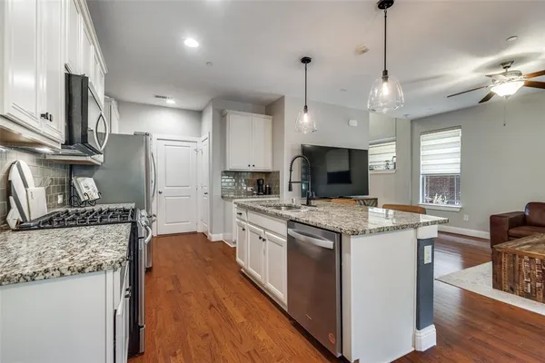 a kitchen with stainless steel appliances granite countertop a stove oven and a refrigerator