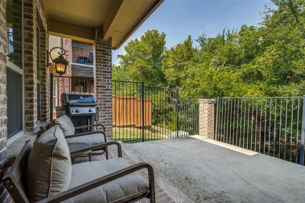 a view of a patio with a table chairs and a potted plant