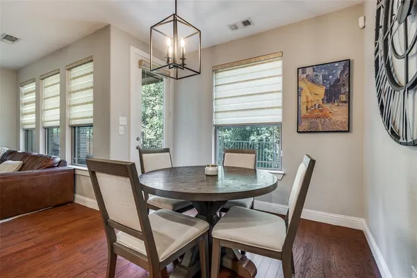 a view of a dining room with furniture wooden floor and a chandelier