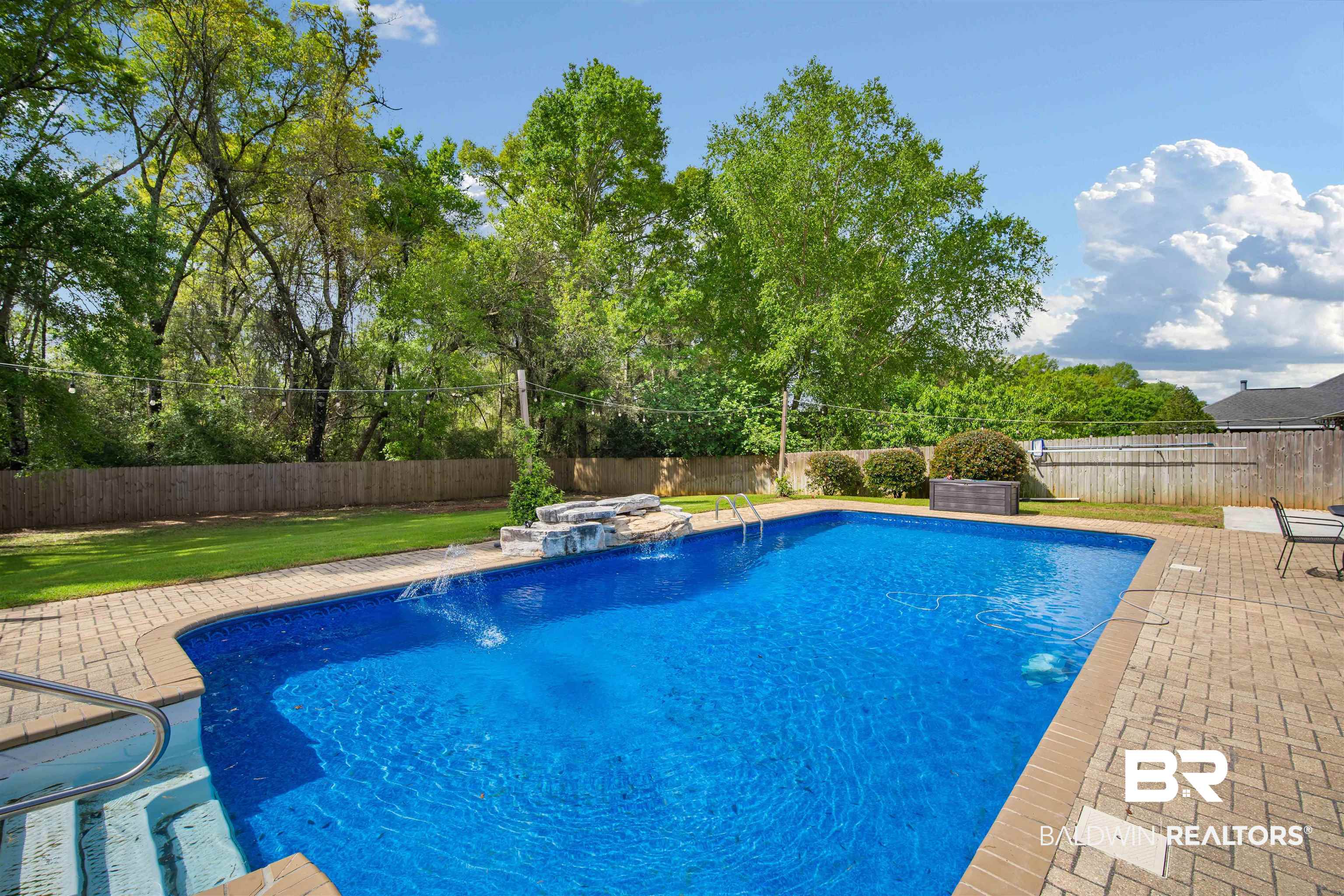 10713 Rigby Drive Mobile, AL 36695 - Photo 32 of 35 View of swimming pool featuring patio surround and a fenced backyard