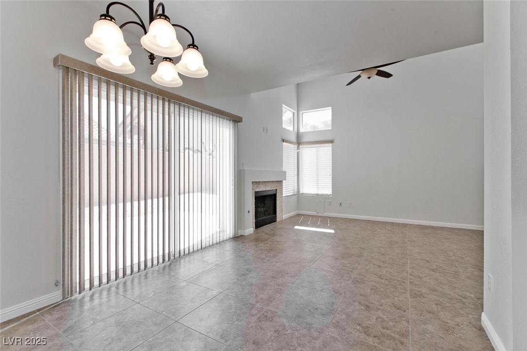 1663 Cloister Avenue Henderson, NV 89014 - Photo 11 of 35 Unfurnished living room with a chandelier, a ceili