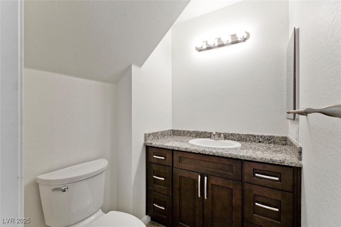 1663 Cloister Avenue Henderson, NV 89014 - Photo 17 of 35 Bathroom featuring vanity and vaulted ceiling