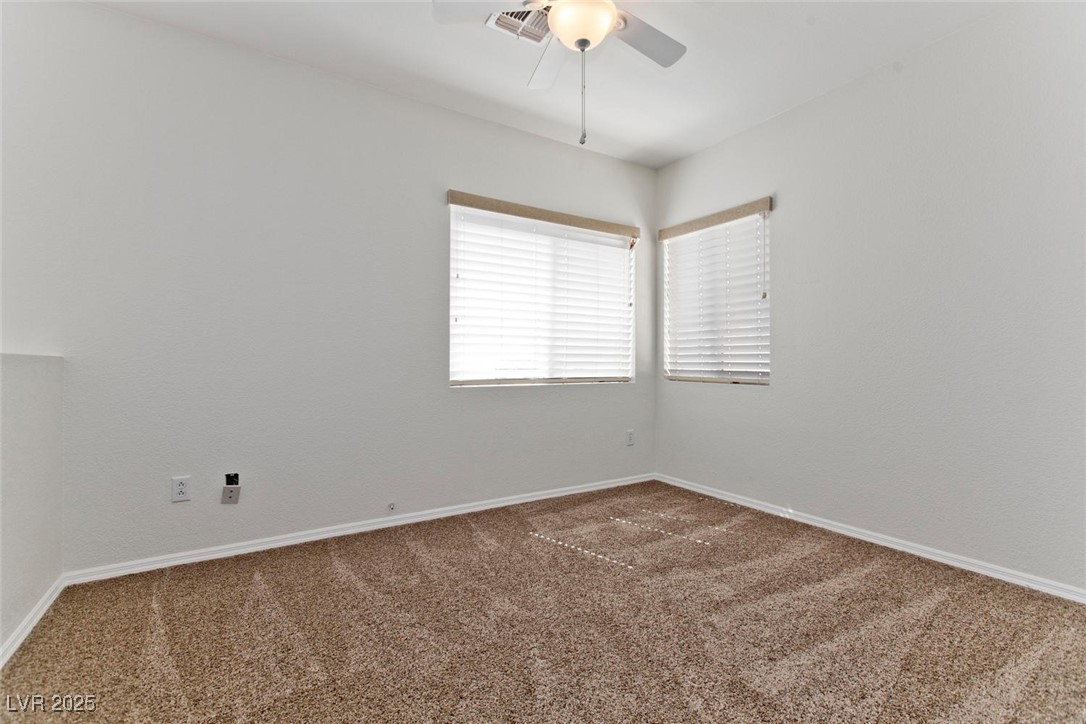 1663 Cloister Avenue Henderson, NV 89014 - Photo 18 of 35 Carpeted empty room with ceiling fan and baseboard