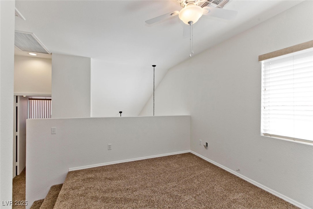 1663 Cloister Avenue Henderson, NV 89014 - Photo 21 of 35 Carpeted empty room featuring a ceiling fan and ba