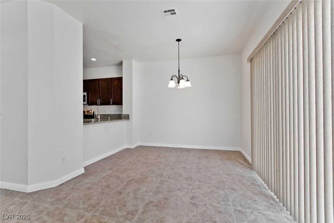 1663 Cloister Avenue Henderson, NV 89014 - Photo 9 of 35 Spare room with a chandelier and recessed lighting