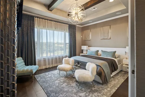 a spacious bedroom with a bed and glass window