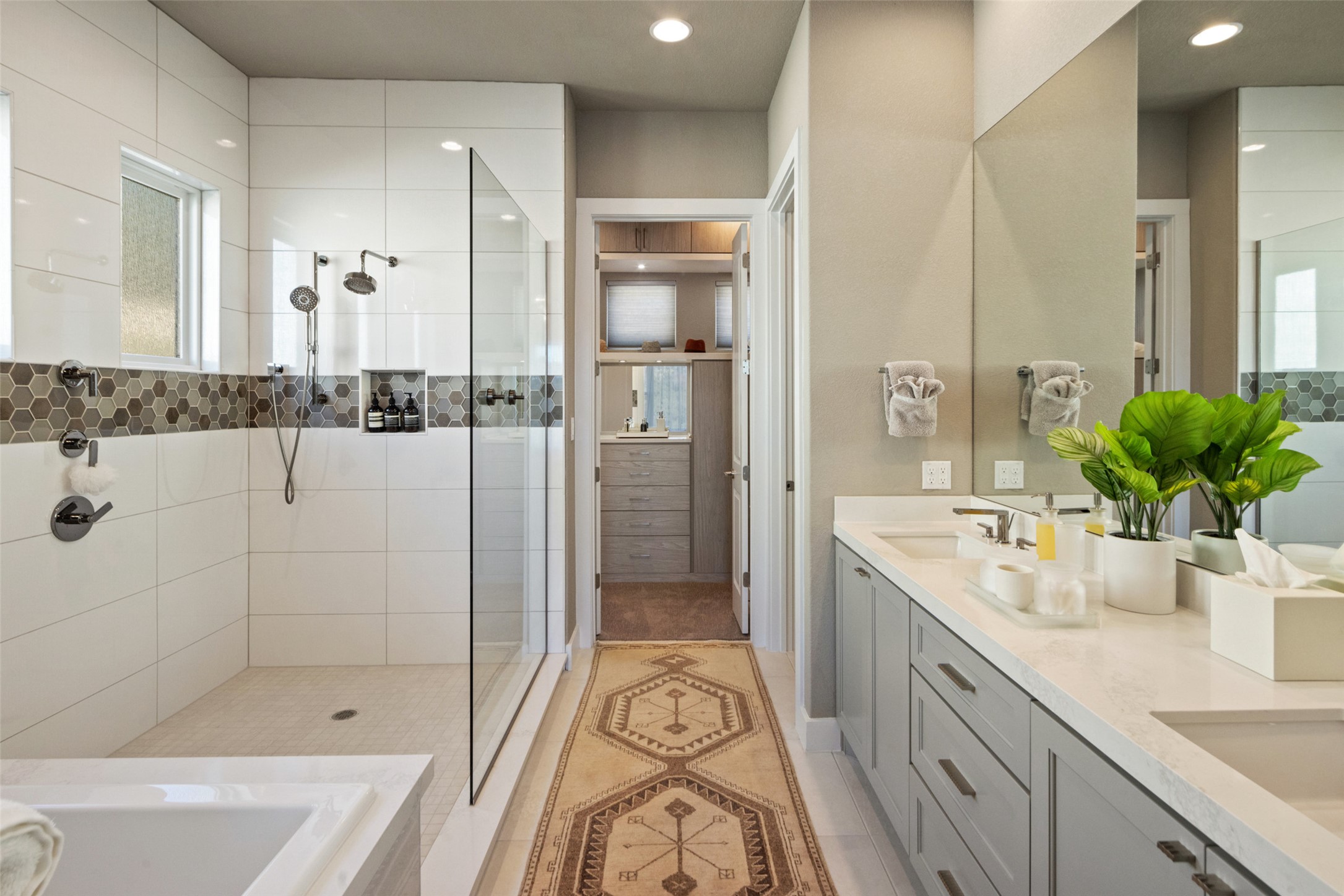 420 Marina View Way Austin, TX 78734 - Photo 15 of 32 a spacious bathroom with a granite countertop tub a double vanity sink a mirror a shower and vanity