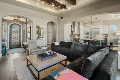 a living room with furniture and a chandelier