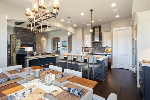 a large kitchen with a table and chairs