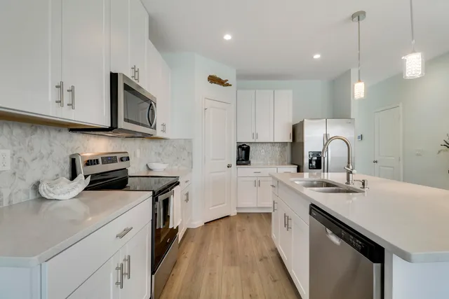 a kitchen with a sink stove and cabinets