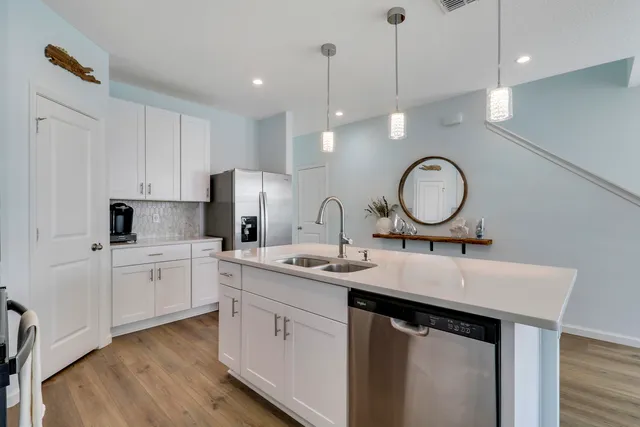 a kitchen with sink stove and cabinets