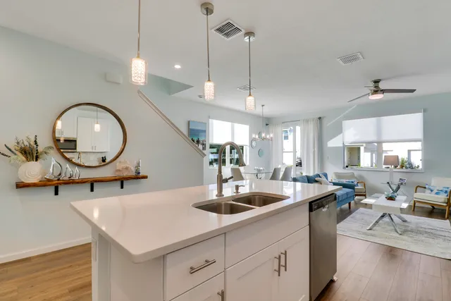 a kitchen with a sink a counter space appliances and cabinets