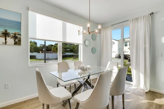 a view of a dining room with furniture wooden floor and a chandelier