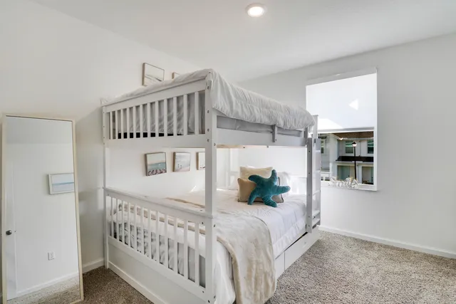 a bedroom with bed and a window