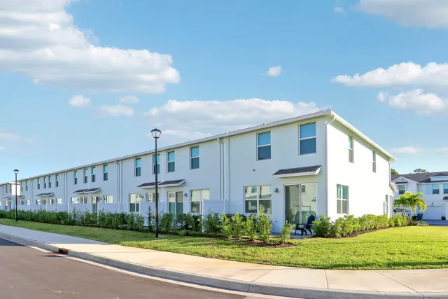 a view of a big building next to a yard
