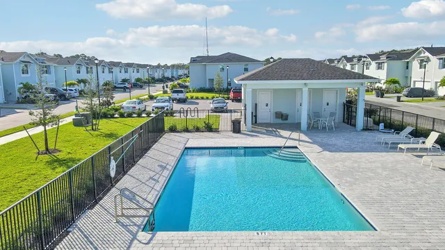 a swimming pool view with a outdoor seating space