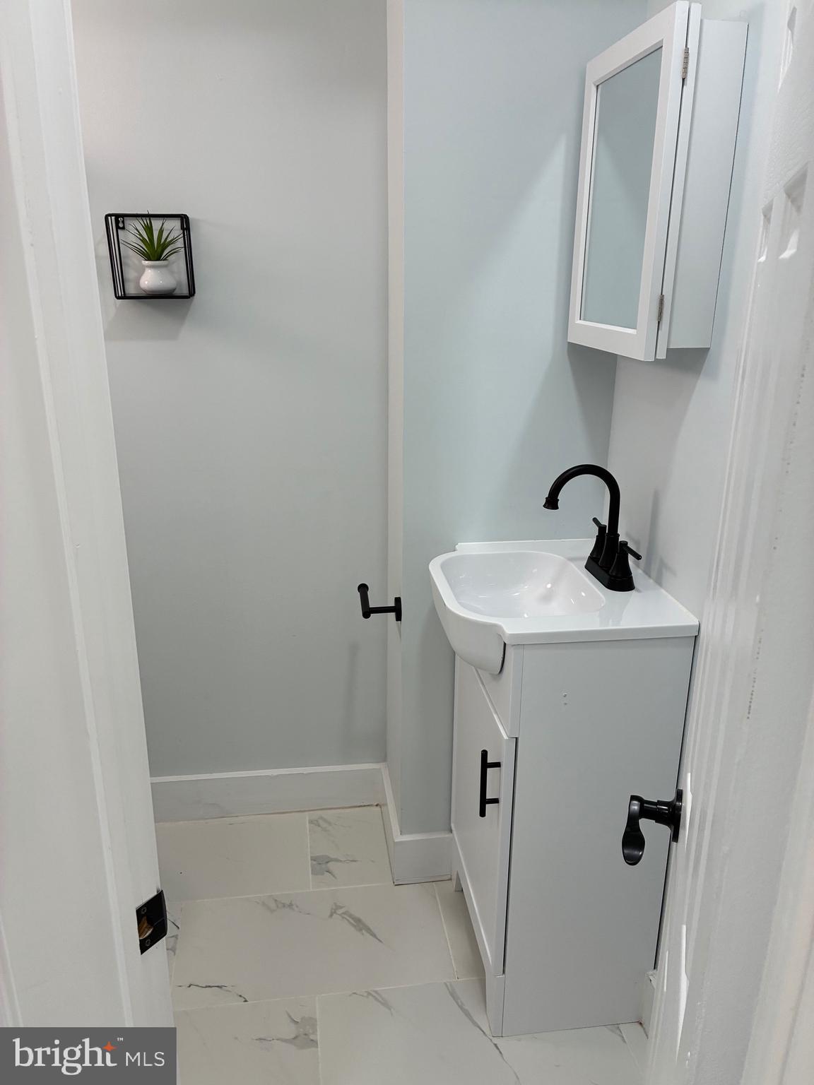 2704 Marbourne Avenue Baltimore, MD 21230 - Photo 13 of 46 a bathroom with a sink a toilet and shower