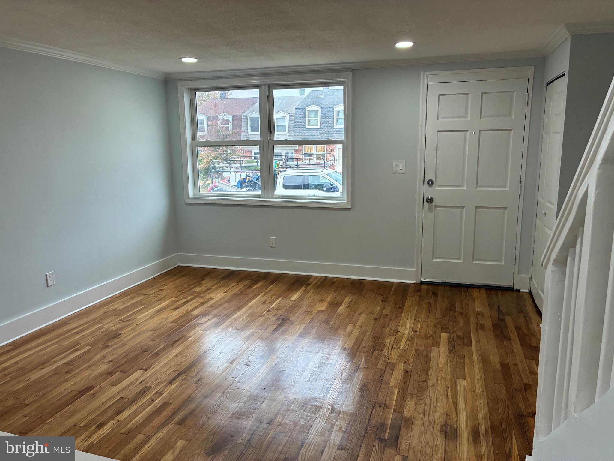 2704 Marbourne Avenue Baltimore, MD 21230 - Photo 15 of 46 a view of an empty room with wooden floor and a window