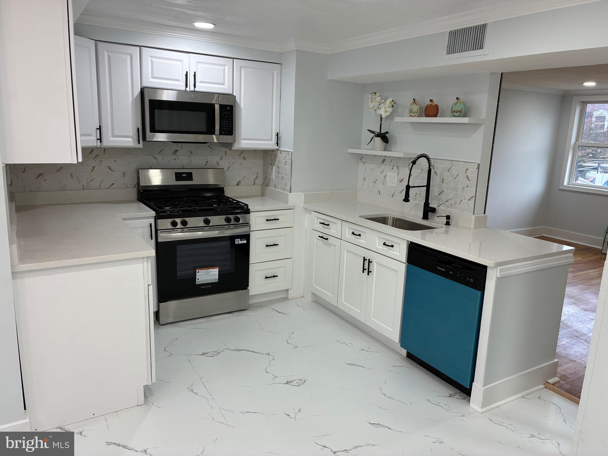 2704 Marbourne Avenue Baltimore, MD 21230 - Photo 2 of 46 a kitchen with a sink stove and microwave