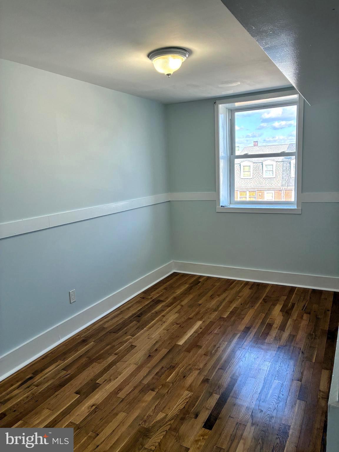 2704 Marbourne Avenue Baltimore, MD 21230 - Photo 26 of 46 an empty room with wooden floor and windows