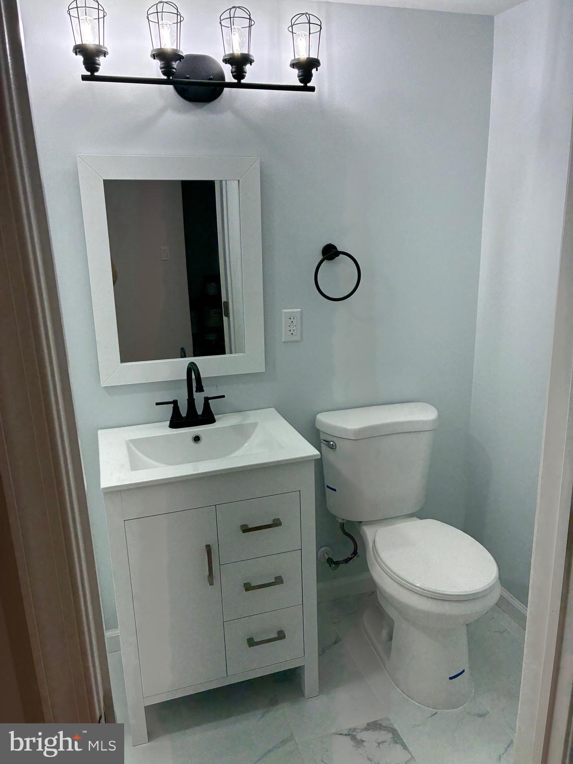 2704 Marbourne Avenue Baltimore, MD 21230 - Photo 34 of 46 a bathroom with a sink a toilet and mirror