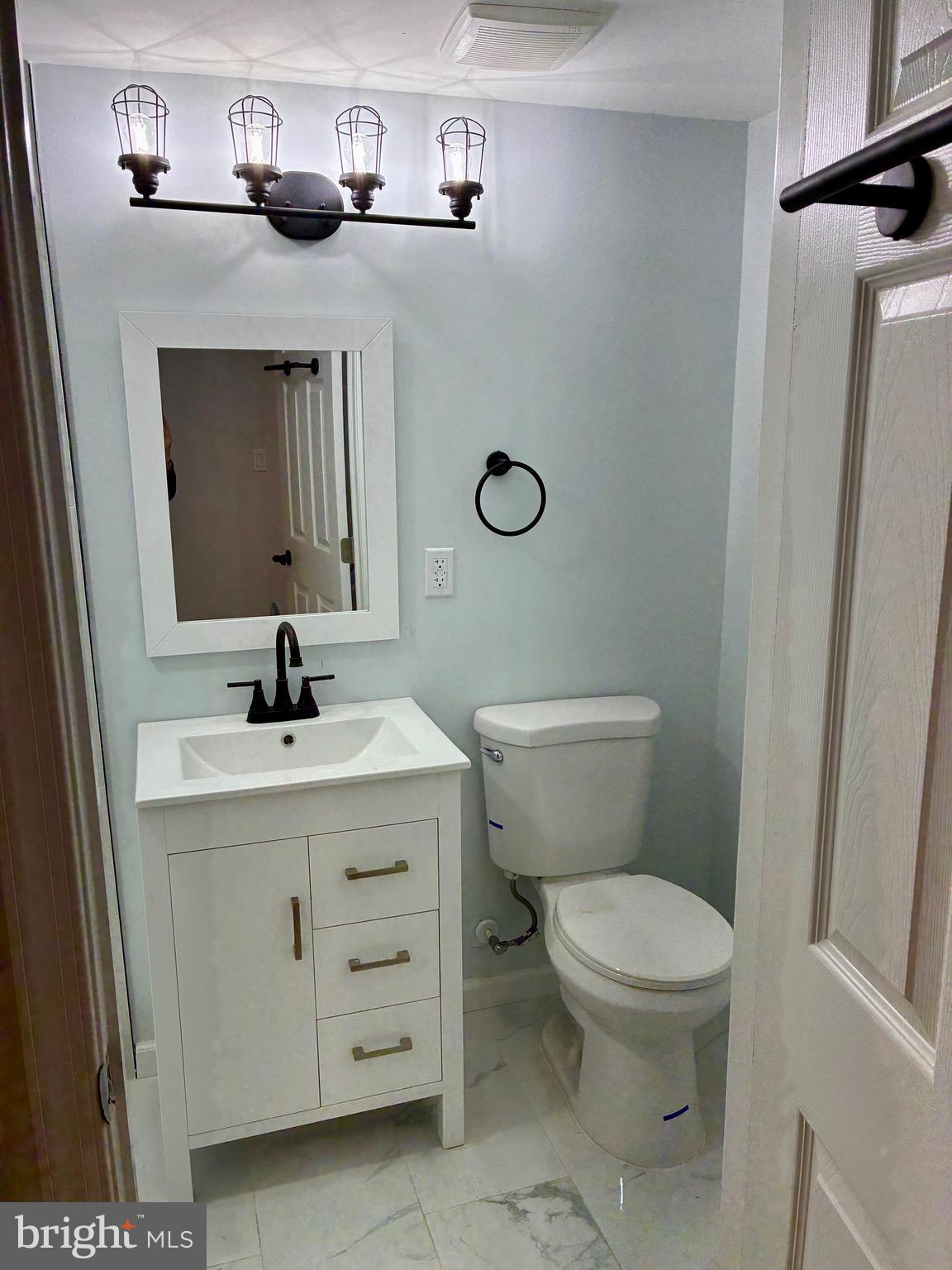 2704 Marbourne Avenue Baltimore, MD 21230 - Photo 35 of 46 a bathroom with a toilet a sink and a mirror